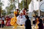 Spanish girls in flamenco dresses on horseback