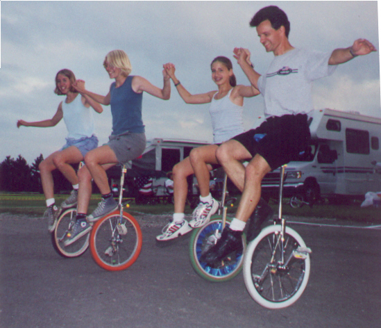 Learning to backwards wheel walk: Tanya, Tammy, and Suzanne Wrobel of RTUC, with teacher Neil Younggren of TCUC.